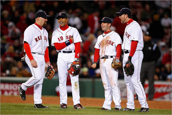 Kevin Youkilis, Julio Lugo, Dustin Pedroia, and Sean Casey  of the Red Sox share a laugh during a game against the New York Yankees at Fenway Park on April 13, 2008 in Boston, Massachusetts.