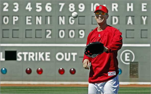 The Boston Red Sox are scheduled to open the 2009 baseball season on Monday afternoon at Fenway Park. The team held a workout this afternoon in preparation. Here leftfielder Jason Bay is all smiles as he plays catch at the start of the practice with the Green Monster  in the backround.