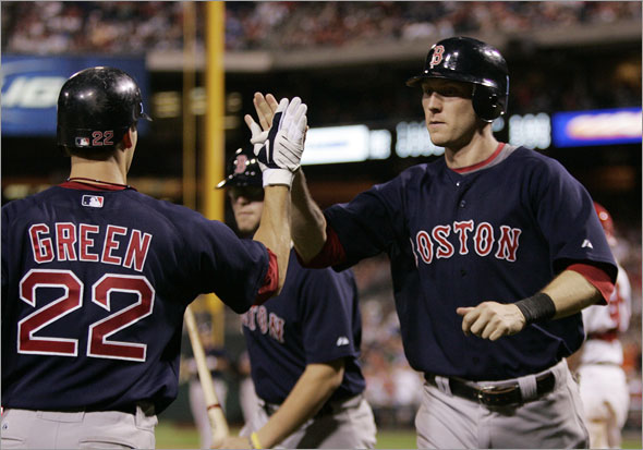 Boston Red Sox' Nick Green, left, hi-fives Jason Bay, right, who scored the winning run on a single by Jacoby Ellsbury in the 13th inning of an interleague baseball game Friday, June 12, 2009, in Philadelphia.