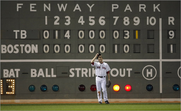 Jason Bay stands in front of the scoreboard during the ninth inning against the Tampa Bay Rays in Game 3 of Major League Baseball's ALCS playoff series in Boston,