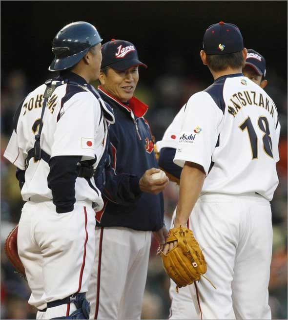 Team Japan's manager Tatsunori Hara takes the ball from Daisuke Matsuzaka (R), as catcher Kenji Johjima watches, in the fifth inning during the semifinals of the World Baseball Classic against Team USA in Los Angeles, California March 22, 2009