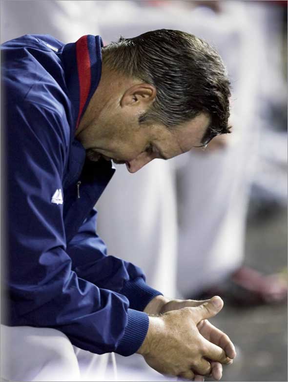 Red Sox starting pitcher Tim Wakefield hangs his head in the dugout after leaving the game in the fifth inning after giving up seven runs against the Los Angeles Angels during a baseball game in Anaheim, Calif., Wednesday, May 13, 2009.