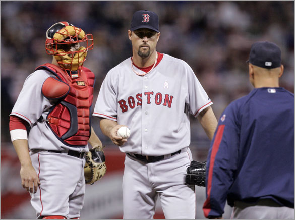 Red Sox pitcher Tim Wakefield gives up the ball to manager Terry Francona, right, after giving up the seventh run to the Minnesota Twins in third  inning of a baseball game Sunday,  May 11, 2008 in Minneapolis. At left is catcher Kevin Cash. 