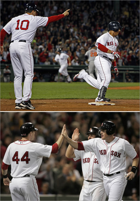 Jason Bay, left, celebrates with teammates Brian Anderson, right, and Kevin Youkilis after all three scored on a three-run double by Red Sox's Victor Martinez in the seventh inning 