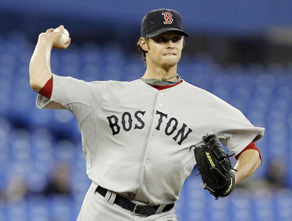 Red Sox pitcher Clay Buchholz throws to first against the Toronto Blue Jays during the first inning of their MLB American League baseball game in Toronto April 27, 2010