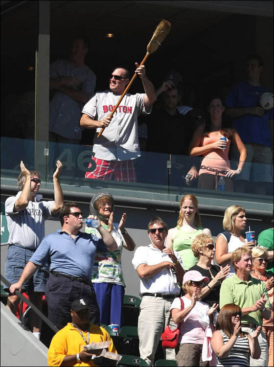 A fan of the Boston Red Sox holds a broom in the suite level as the Red Sox sweep a four game series from the Chicago White Sox on August 26, 2007 at US Cellular Field in Chicago, Illinois. 