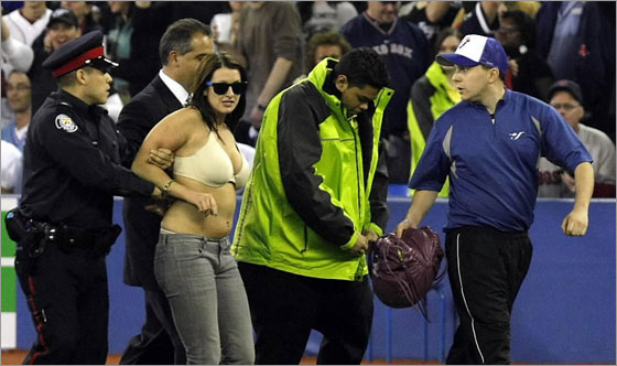 A woman who ran onto the field is arrested and escorted off the field by police in the ninth inning of the Toronto Blue Jays game against the Boston Red Sox at the Blue Jays' home-opener at the Rogers Centre April 4, 2008 in Toronto, Ontario, Canada. g