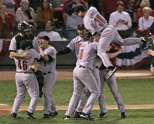 Houston Astros Luke Scott (30) leaps on top of his teammates as they celebrate their 5-1 victory over the St. Louis Cardinals in Game 6 to win the National League Championship pennant in St. Louis, Wednesday, Oct. 19, 2005.