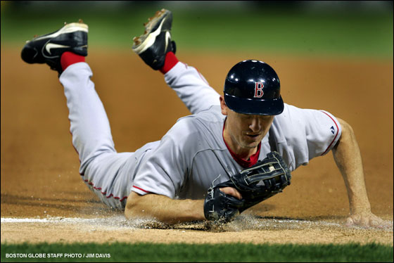 Red Sox first baseman John Olerud makes a great diving stop of a ball on the foul line off the bat of Chicago's Scott Podsednik. He held on, got up and tossed to David Wells covering for the first out of the bottom of the fourth inning.