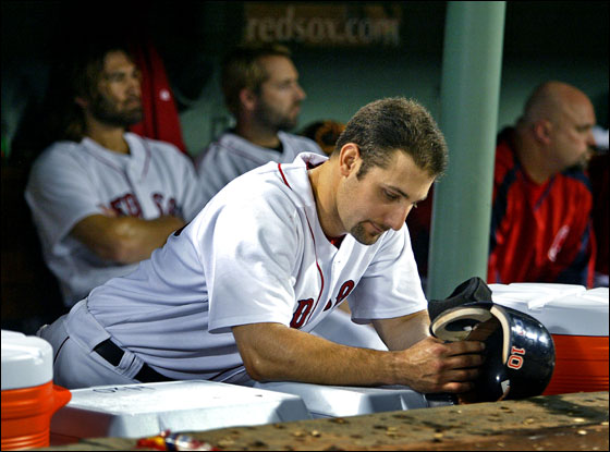 The Red Sox dugout is a glum place after the last out of the game ended Boston's season. In the foreground is Tony Graffanino, in the backround, left to right are Johnny Damon, Kevin Millar, and David Wells.