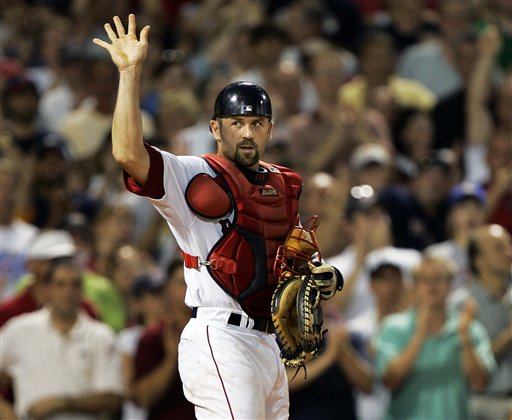 Red Sox catcher Jason Varitek acknowledges the fans after it was announced that he is catching his team record 991th baseball game during the sixth inning against the Kansas City Royals at Fenway Park in Boston Tuesday, July 18, 2006. 