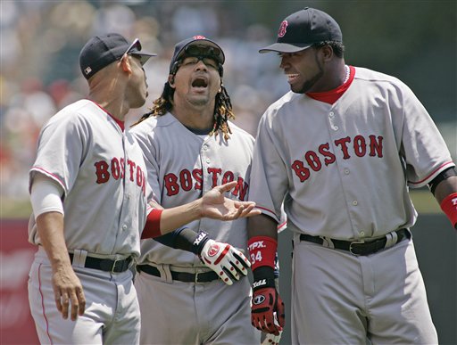Red Sox' Alex Cora, Manny Ramirez and David Ortiz, from left, joke around while warming up before a baseball game against the Chicago White Sox in Chicago, Saturday, July 8, 2006.