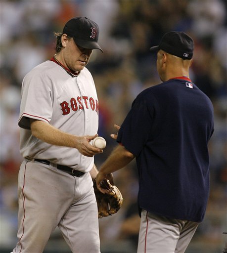 Red Sox starting pitcher Curt Schilling, left, hands the ball over to manager Terry Francona as he leaves a baseball game against the Kansas City Royals in the eighth inning Thursday, Aug. 10, 2006, in Kansas City, Mo. The Royals rallied for three runs in the eighth inning to beat Schilling and the Red Sox 5-4.