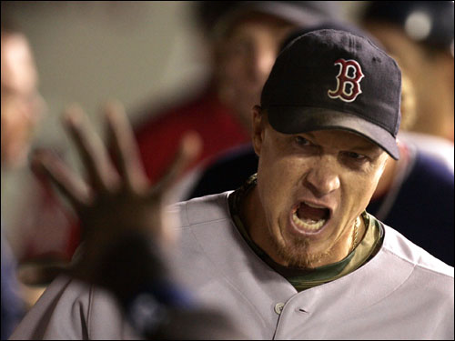 Red Sox pitcher Mike Timlin celebrated in the dugout after retiring the side with the bases loaded in the seventh inning.