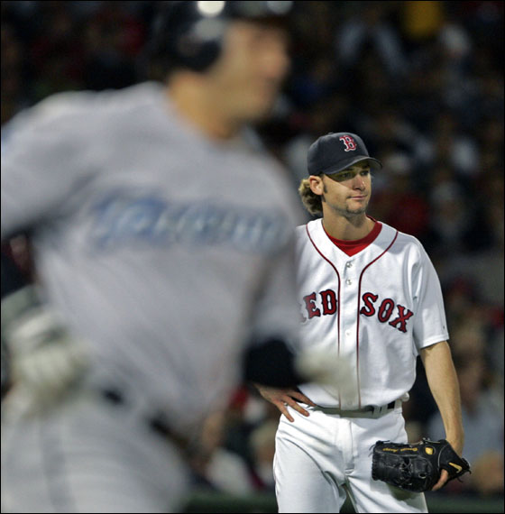 Red Sox starter Bronson Arroyo (right) watches as a third inning home run off the bat of Toronto's Frank Catalanotto (left) sails out of the park.