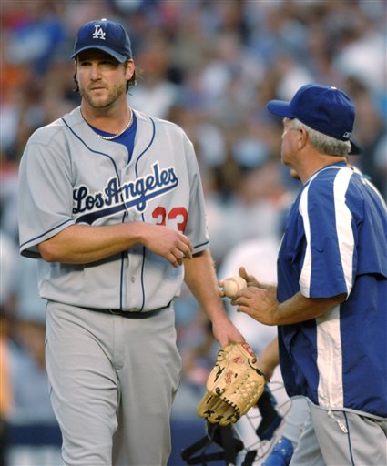 Los Angeles Dodgers pitcher Derek Lowe leaves the game after handing the ball to manager Grady Little, right, in the sixth inning of Game 1 of the National League Division Series against the New York Mets at Shea Stadium in New York on Wednesday, Oct. 4, 2006. The Mets won 6-5.