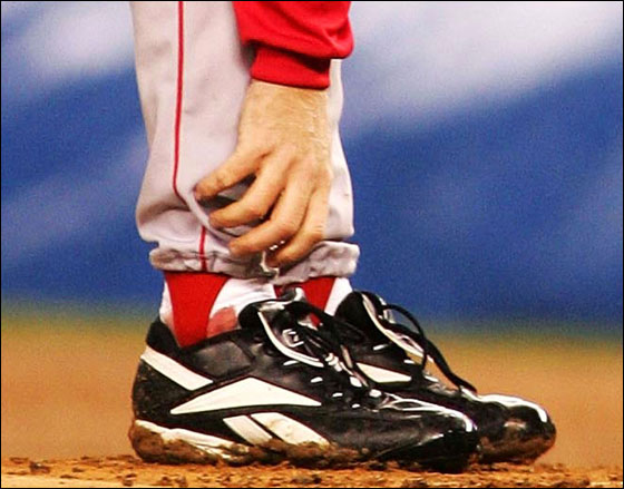 Pitcher Curt Schilling of the Red Sox grabs at his ankle as it appears to be bleeding in the fourth inning during game six of the American League Championship Series against the New York Yankees on October 19, 2004 at Yankee Stadium in the Bronx borough of New York City.