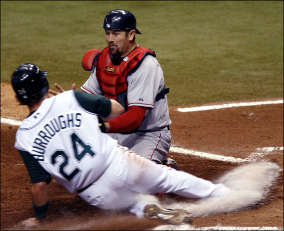 Sean Burroughs of the Tampa Bay Devil Rays slides into home safely where Catcher Jason Varitek of the Boston Red Sox missed the tag April 28, 2006 at Tropicana Field in St. Petersburg, Florida.