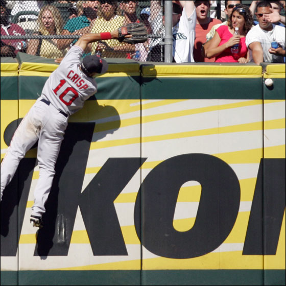 Red Sox center fielder Coco Crisp misses a ball hit Seattle Mariners' Adrian Beltre during the eighth inning of their baseball game in Seattle Sunday, July 23, 2006. Beltre legged out an inside-the-park home run on the play. The Mariners went on to win 9-8.
