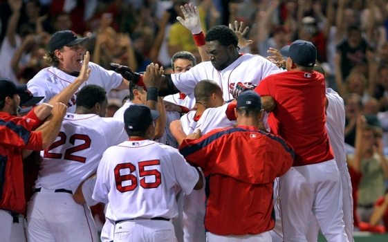 Red Sox DH David Ortiz is mobbed at the plate as he comes across on yet another game winning walk off home run, this one a three run blast that gave Boston a 9-8 victory.