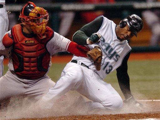 Tampa Bay Devil Rays' Carl Crawford (13) beats the tag from Red Sox catcher Jason Varitek as he steals home during the fourth inning of a baseball game Wednesday, July 5, 2006, in St. Petersburg, Fla.