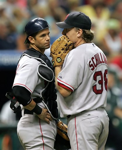 Red Sox pitcher Curt Schilling, right, talks with the team's newly acquired catcher, Javy Lopez, during the sixth inning of a baseball game with the Tampa Bay Devil Rays on Friday night, Aug. 4, 2006, in St. Petersburg, Fla. Lopez was traded from the Baltimore Orioles earlier in the day. He came into the game in the second inning after Doug Mirabelli injured his ankle.