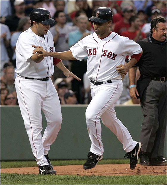 Doug Mirabelli, at far left, greets Alex Cora at home after they both scored on a bases loaded single by Mark Loretta in a 6 run 2nd inning.