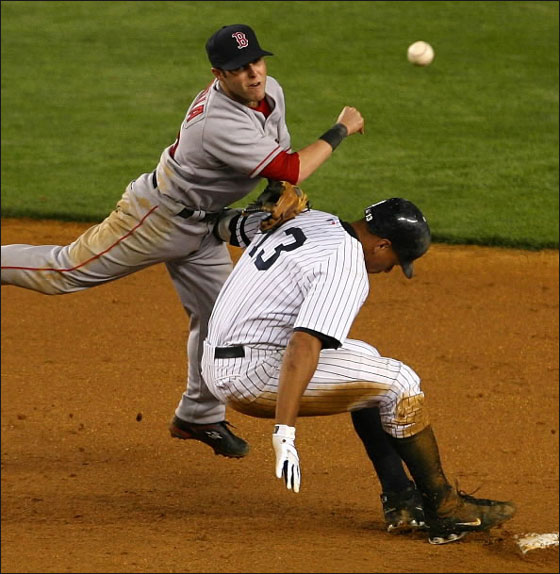 Dustin Pedroia of the Red Sox throws to first as Alex Rodriguez  of the New York Yankees breaks up the double play in the 8th inning 22 May 2007 at Yankee Stadium in the Bronx borough of New York City.
