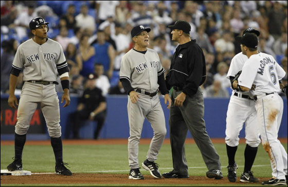New York Yankees' Alex Rodriguez (L) and third base coach Larry Bowa argue with Toronto Blue Jays players Howie Clark and John McDonald as umpire Chad Fairchild (C) watches during the ninth inning of their MLB American League baseball game in Toronto May 30, 2007