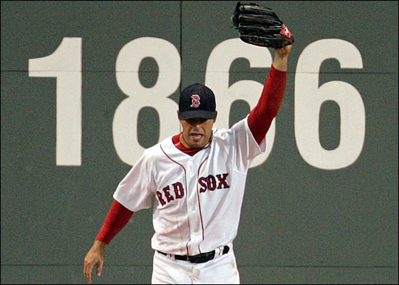 Red Sox Adam Stern raises his glove after hitting the wall while making a catch against the Tampa Bay Devil Rays in the sixth inning of MLB action in Boston, Massachusetts April 19, 2006.