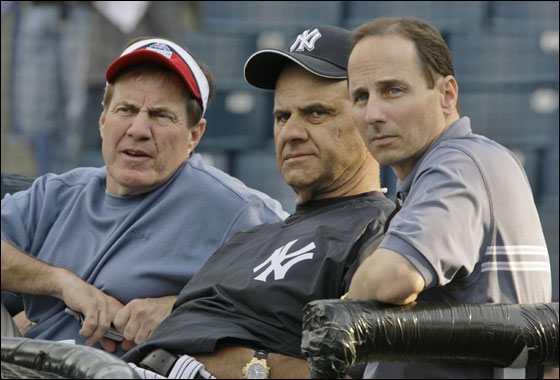 New England Patriots head coach Bill Belichick, left, New York Yankees manager Joe Torre, center, and Yankees general manager Brian Cashman chat while seated behind the batting cage as the Yankees and Tampa Bay Devil Rays warmed up before their spring training game at Legends Field in Tampa, Fla., Friday, March 9, 2007.