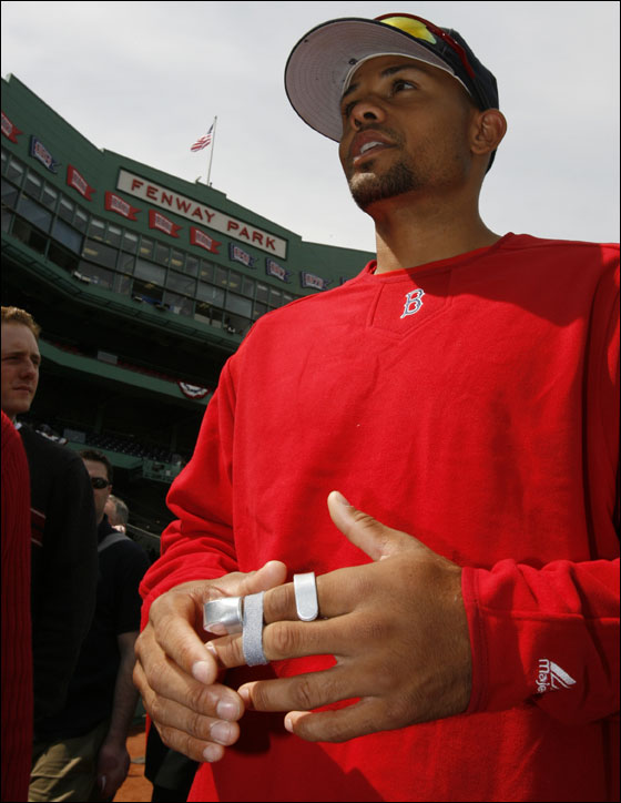 Red Sox Coco Crisp talking to reporters with his left knuckle in a splint after breaking it on a steal attempt of third base in Baltimore before the start of their home season opener at Fenway Park