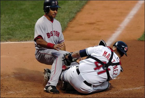 Indians catcher Victor Martinez blocks home plate to prevent Boston Red Sox's Coco Crisp from scoring in the sixth inning of their MLB American League baseball game in Cleveland, Ohio July 25, 2007. Crisp attempted to score from second base on David Ortiz single to short center.