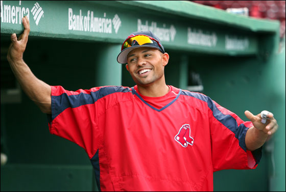 With his newly signed three year contract extension all done, injured Red Sox centerfielder Coco Crisp has a chuckle while standing under an appropriate sign in the home dugout during batting practice.