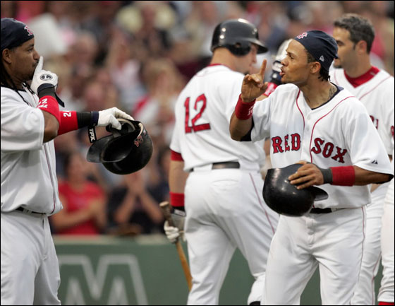 The Boston Red Sox Coco Crisp, right and Manny Ramirez signal quiet after Crisp hit a grand slam home run during 1st inning action against the Tampa Bay Devil Rays at Fenway Park on Thursday July 5, 2007