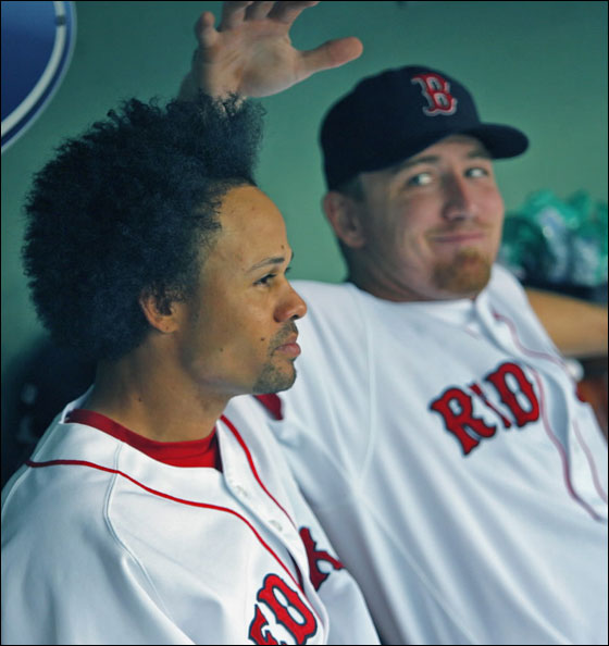 Red Sox rightfielder J.D. Drew, (right), has some fun as he checks out the latest hairstyle of teammate Coco Crisp in the dugout before the game.