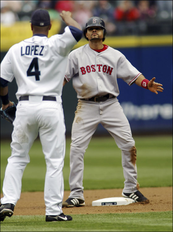 Red Sox baserunner Coco Crisp (R) reacts after getting caught stealing second base by Seattle Mariner second baseman Jose Lopez (4) during the first inning of their MLB American League baseball game at Safeco Field.