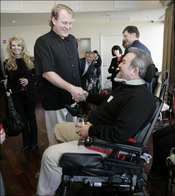 Boston, MA 12/03/06 Boston Red Sox pitcher Curt Schilling and his wife Shonda host a private reception to thank 2006 Curt's Pitch for ALS members in Boston, MA on Sunday, December 3, 2006. Curt is greeting Keith Moegle of Hull. Keith is an ALS patient.