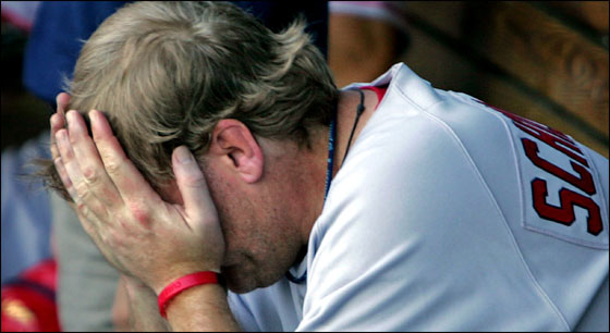 Red Sox starting pitcher Curt Schilling is despondent in the dugout after the bottom of the fourth inning, in which Kansas City scored three times off of him. It would be his last inning of the game.