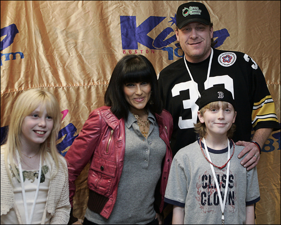 Curt Schilling poses with Canadian singer-songwriter Nelly Furtado and his two children Gabriella, left, and Gehrig backstage at the Kiss 108 Boston Jingle Ball at the Tsongas Arena in Lowell, Mass., Thursday, Dec. 14, 2006