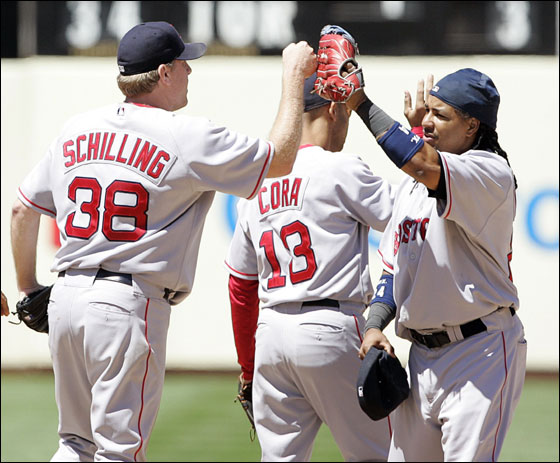 Boston Red Sox Curt Schilling is congratulated by Manny Ramirez after beating the Oakland Athletics in Oakland, California, June 7, 2007. 