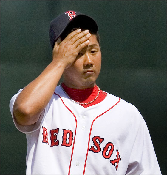 Red Sox pitcher Daisuke Matsuzaka wipes his brow after giving up a fourth inning home run against the Orioles. It was the second HR Matsuzaka gave up.
