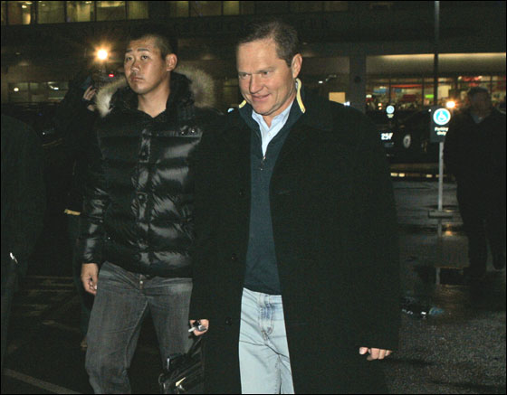 Japanese pitcher Daisuke Matsuzaka arrives with his agent Scott Boras, right, in Boston, Wednesday, Dec. 13, 2006, as negotiations with the Boston Red Sox neared agreement on a $52 million, six-year contract.