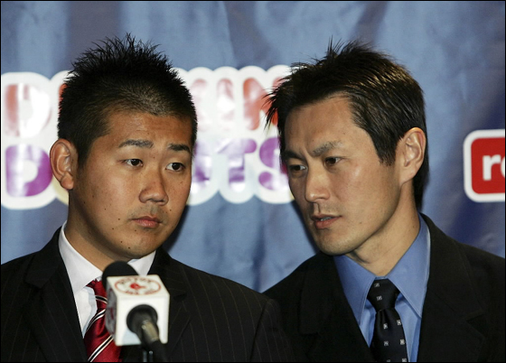 Daisuke Matsuzaka looks on as Tak Sato translates for him during a press conference announcing that the pitcher has signed with the Boston Red Sox on December 14, 2006 at Fenway Park in Boston, Massachusetts. Matsuzaka will get $52 million over six years.