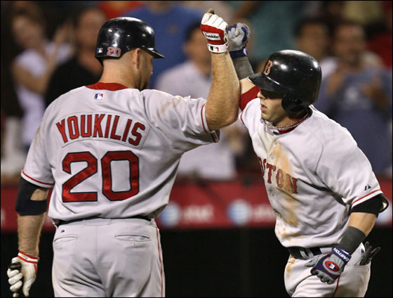 Red Sox second baseman Dustin Pedroia, right, gets kudos from on deck batter Kevin Youkilis after hitting a solo homer against the Los Angeles Angels in the seventh inning of a baseball game in Anaheim, Calif., Wednesday, Aug. 8, 2007. 