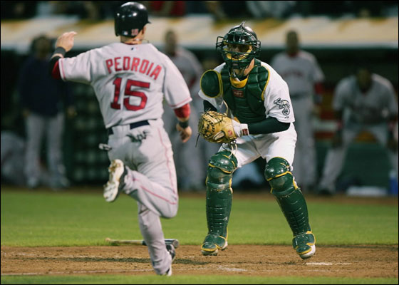 OAKLAND, CA - JUNE 04: Dustin Pedroia #15 of the Boston Red Sox waits to be tagged out at home by Jason Kendall #18 of the Oakland Athletics on a ball hit by David Ortiz in the ninth inning during a Major League Baseball game on June 4, 2007 at McAfee Coliseum in Oakland, California. 