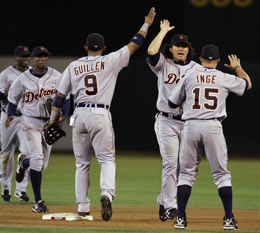 Detroit Tigers' Carlos Guillen (9), Magglio Ordonez and Brandon Inge celebrate their 8-5 victory over the Oakland Athletics in Game 2 of the American League Championship Series in Oakland, Calif., Wednesday, Oct. 11, 2006. The Tigers lead the series 2-0 games.
