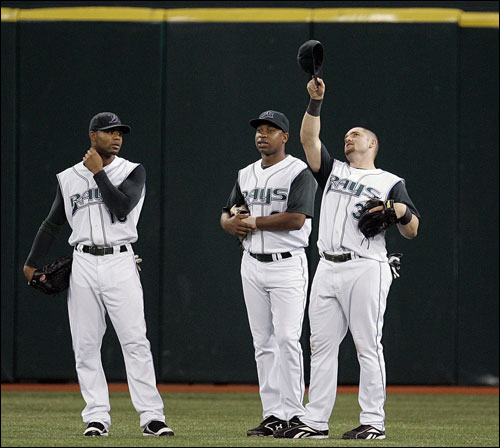 Tampa Bay Devil Rays outfielders, from right, Jonny Gomes, Delmon Young, and Carl Crawford, stand together during a pitching change in the eighth inning of a baseball game against the Chicago White Sox, Wednesday night, June 27, 2007, in St. Petersburg, Fla. Delmon Young had just misplayed a fly ball by Jim Thome.