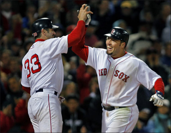 The Red Sox took the lead in the seventh inning on a two run home run by Eric Hinske, who is greeted by the man who scored ahead of him, Jason Varitek (left) after he crossed the plate.