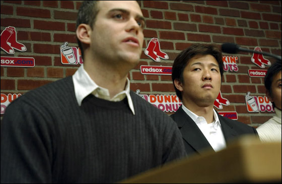 Hideki Okajima (R) listens as Red Sox Executive Vice President and General Manager Theo Epstein (L) introduces him at Fenway Park November 30, 2006 in Boston, Massachusetts. Okajima, 30, signed a multi-year contract with the Red Sox after being one of the top setup relievers in Japan
